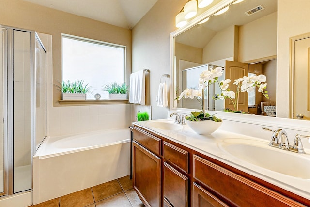 bathroom featuring tile patterned floors, separate shower and tub, vanity, and lofted ceiling