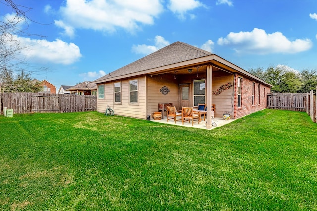 rear view of property featuring a patio and a lawn