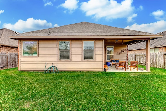 back of house featuring a lawn and a patio area