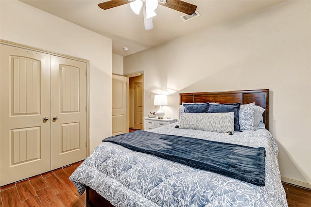 bedroom with a closet, hardwood / wood-style floors, and ceiling fan