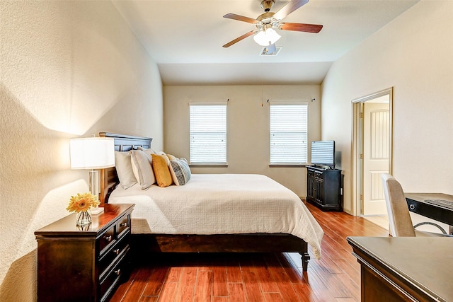 bedroom with hardwood / wood-style flooring, ceiling fan, and lofted ceiling