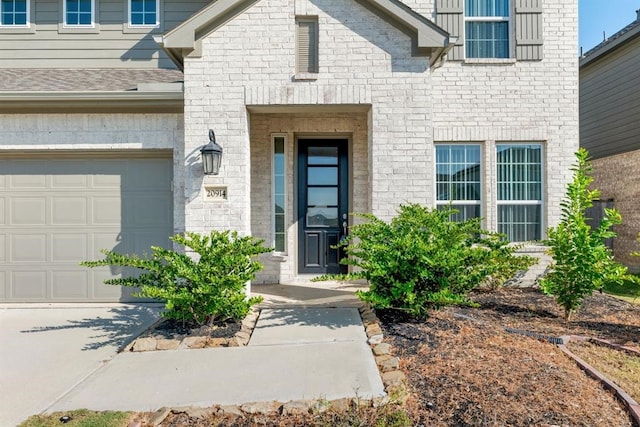 doorway to property with a garage