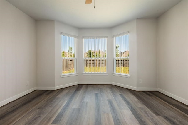 empty room featuring ceiling fan and dark wood-type flooring