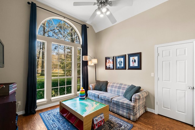 living room with ceiling fan, vaulted ceiling, and hardwood / wood-style floors