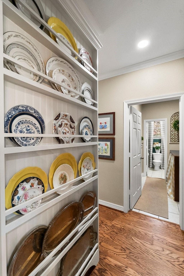 details featuring wood-type flooring and crown molding