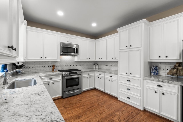 kitchen with white cabinetry, appliances with stainless steel finishes, and sink