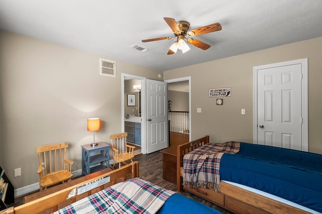 bedroom featuring ceiling fan, dark wood-type flooring, and ensuite bathroom