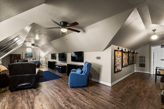 home theater with a textured ceiling, ceiling fan, lofted ceiling, and dark hardwood / wood-style flooring