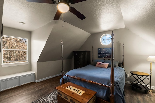 bedroom with ceiling fan, lofted ceiling, dark hardwood / wood-style flooring, and a textured ceiling