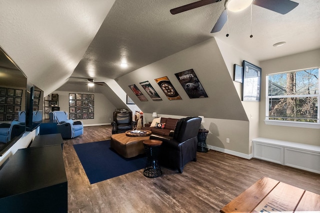 cinema featuring ceiling fan, lofted ceiling, wood-type flooring, and a textured ceiling