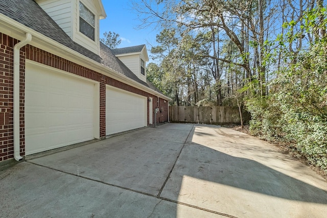 view of side of home featuring a garage