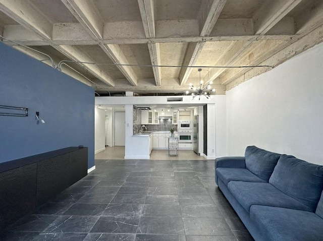 living area with baseboards, beam ceiling, and an inviting chandelier