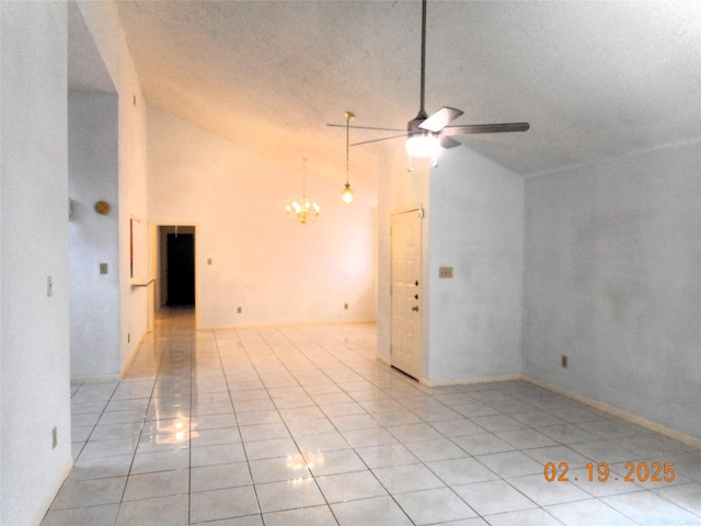 tiled spare room featuring a textured ceiling, high vaulted ceiling, and ceiling fan with notable chandelier