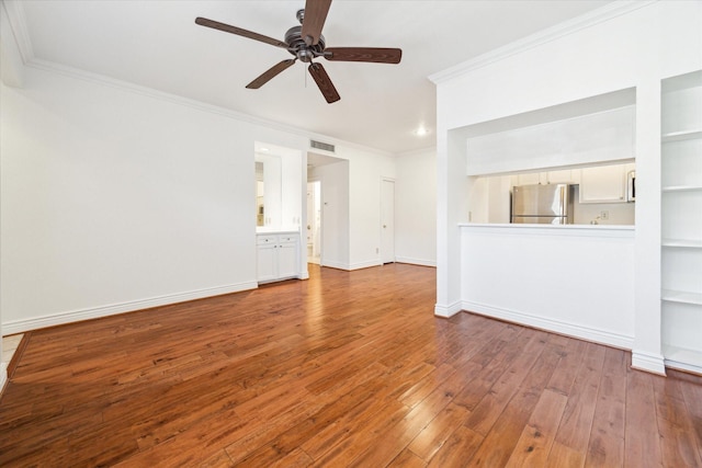 unfurnished living room with built in features, ornamental molding, ceiling fan, and wood-type flooring