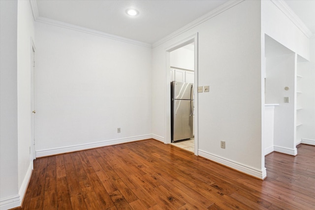 unfurnished bedroom with light hardwood / wood-style floors, crown molding, and stainless steel fridge