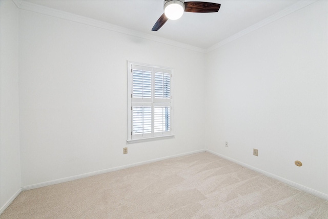 unfurnished room featuring ceiling fan, crown molding, and light colored carpet