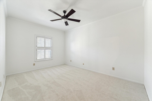 carpeted spare room featuring ceiling fan and crown molding