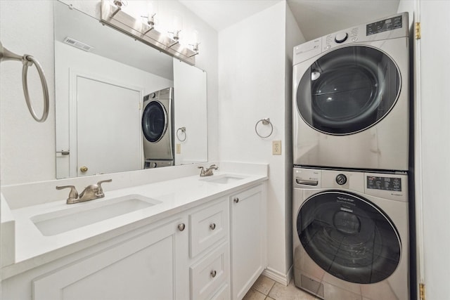 laundry room with sink, stacked washer / drying machine, and light tile patterned flooring