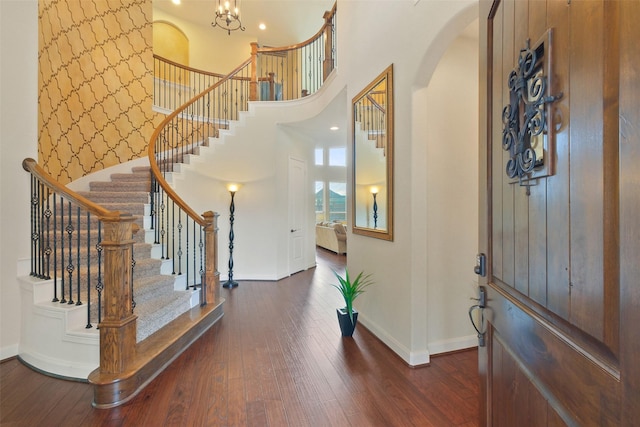 foyer with a high ceiling and dark hardwood / wood-style floors