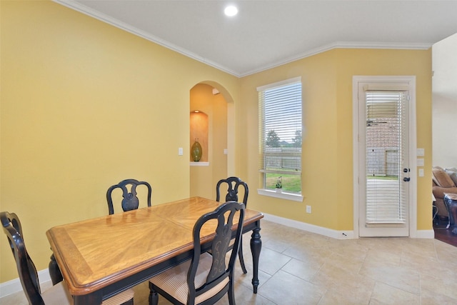 tiled dining area featuring ornamental molding