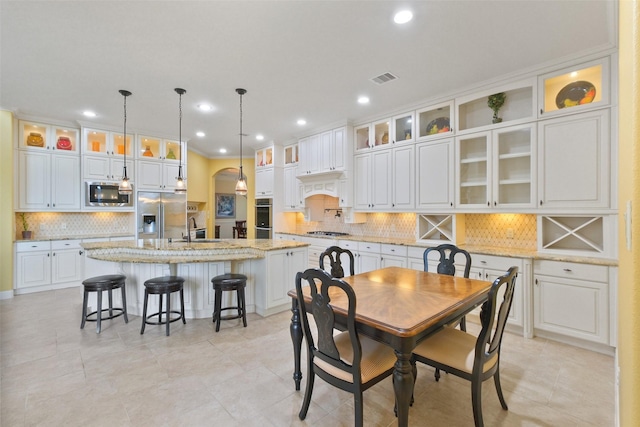 dining area with light tile patterned flooring and sink