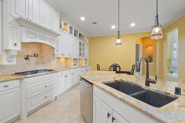 kitchen with sink, stainless steel dishwasher, white cabinets, hanging light fixtures, and gas cooktop