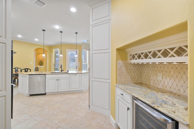 kitchen featuring white cabinetry, stainless steel dishwasher, sink, and beverage cooler