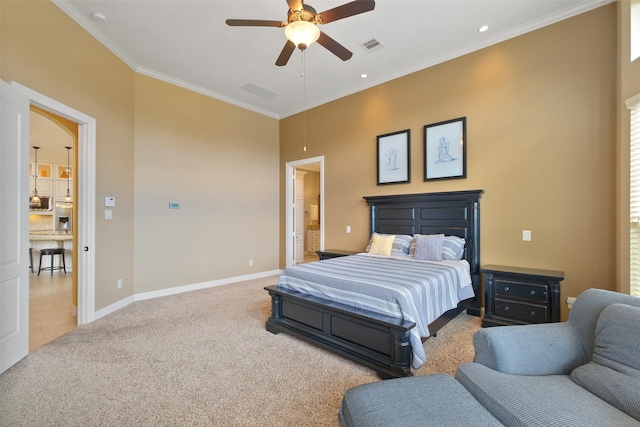 bedroom featuring light carpet, ceiling fan, ensuite bath, and ornamental molding