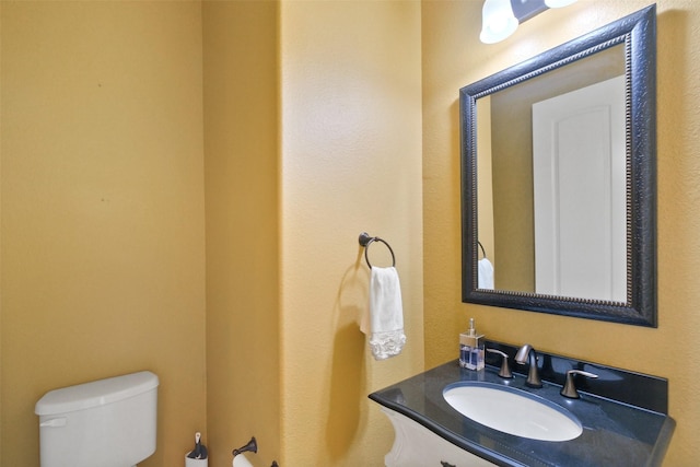 bathroom featuring toilet and vanity