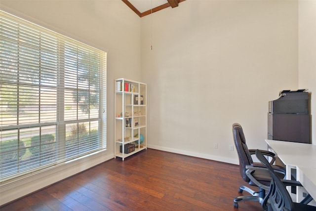 office space featuring a high ceiling and dark hardwood / wood-style flooring