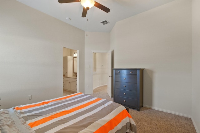 bedroom featuring ceiling fan, connected bathroom, and light colored carpet