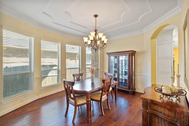 dining space featuring dark hardwood / wood-style flooring, a chandelier, and crown molding