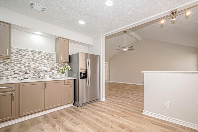 kitchen with light wood finished floors, light countertops, visible vents, a sink, and stainless steel fridge with ice dispenser