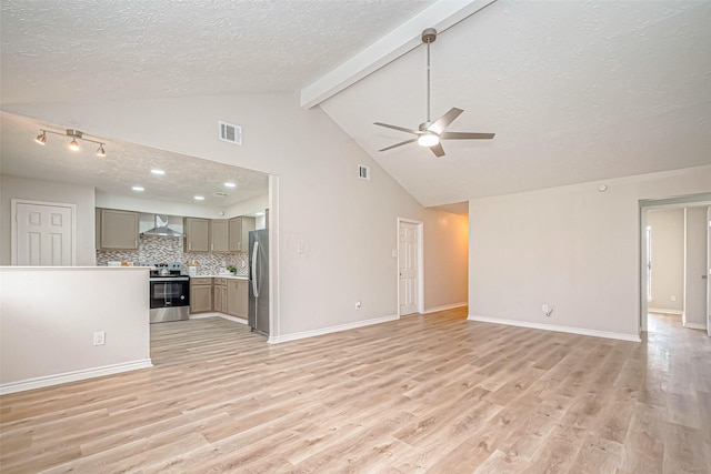 unfurnished living room featuring a textured ceiling, light wood finished floors, visible vents, and baseboards