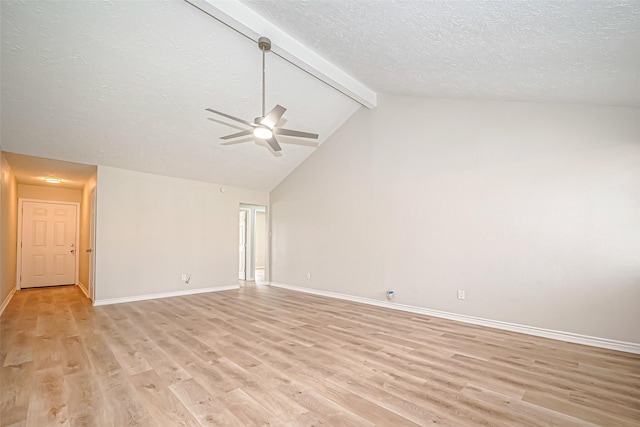 unfurnished living room with light wood finished floors, baseboards, ceiling fan, a textured ceiling, and beam ceiling