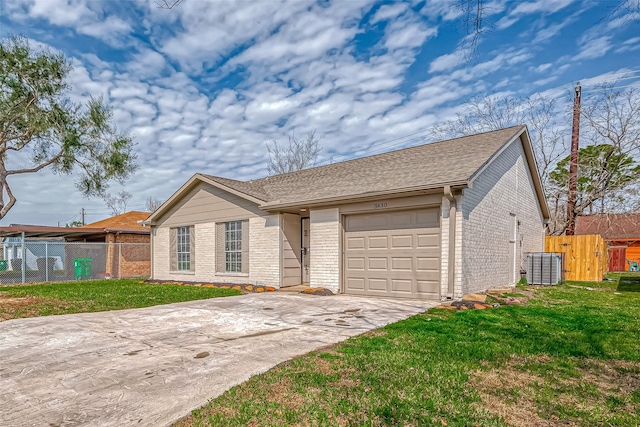 ranch-style home featuring brick siding, fence, and a front lawn