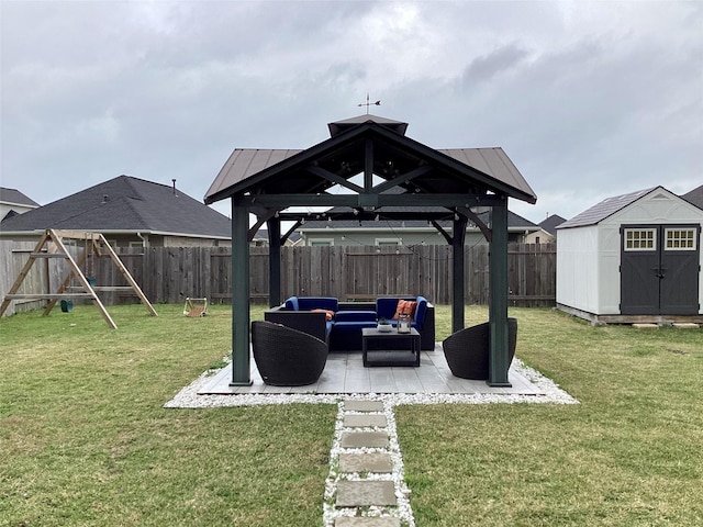 view of yard featuring an outdoor hangout area, a patio, a shed, a playground, and a gazebo