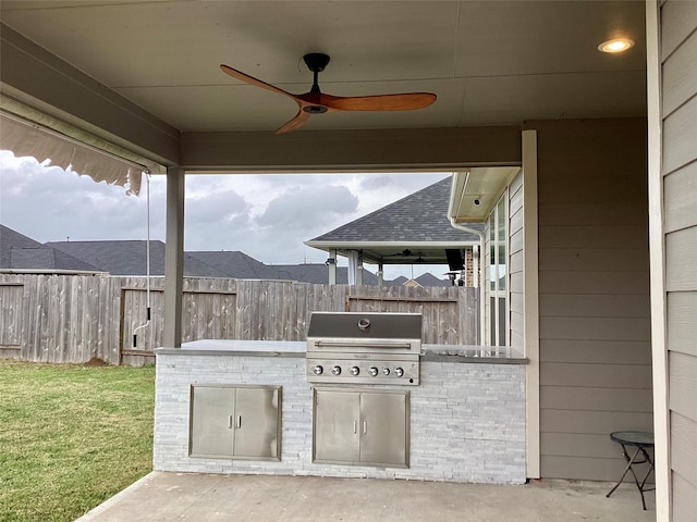 view of patio with ceiling fan, an outdoor kitchen, and a grill