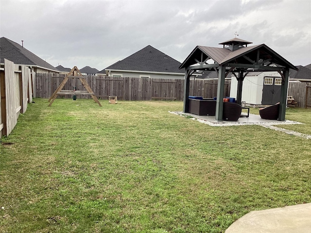 view of yard featuring a patio, a gazebo, and a playground