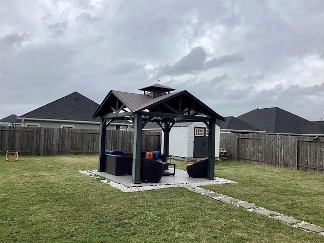 view of play area with a shed, a yard, and a gazebo