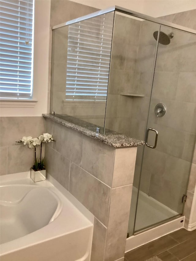 bathroom featuring plus walk in shower