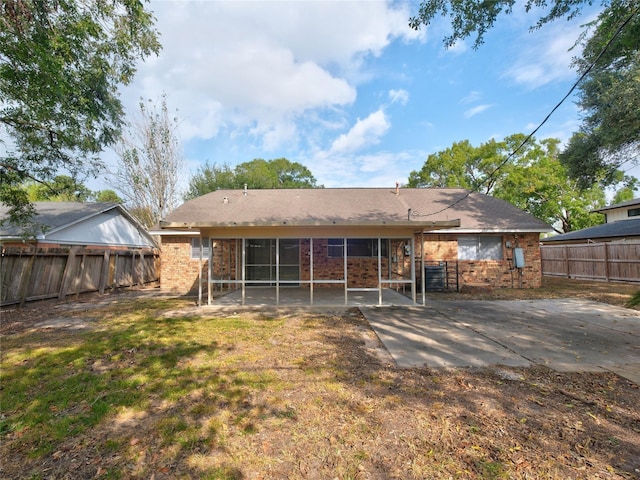 back of property featuring a yard and a patio