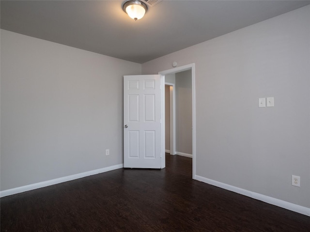 empty room with dark hardwood / wood-style floors