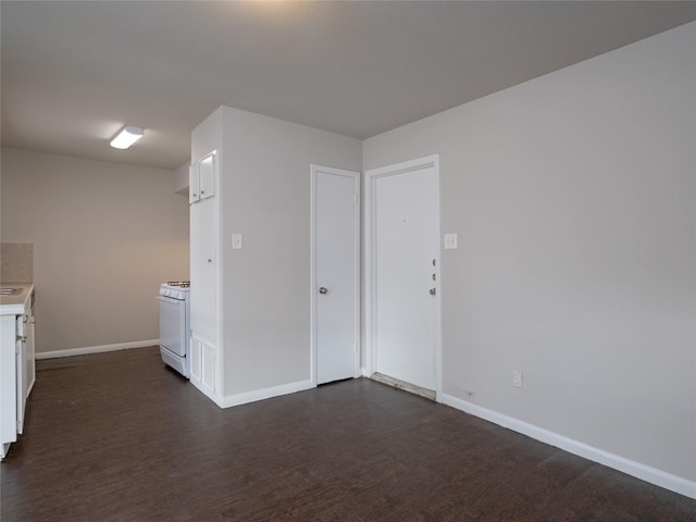 empty room with dark wood-type flooring