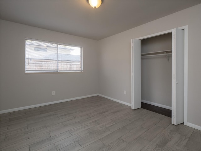 unfurnished bedroom featuring a closet and light hardwood / wood-style flooring