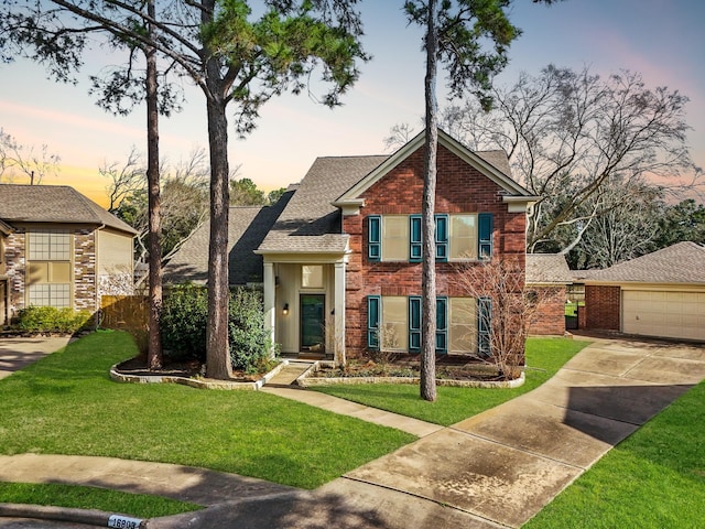 view of front of property with a lawn and a garage