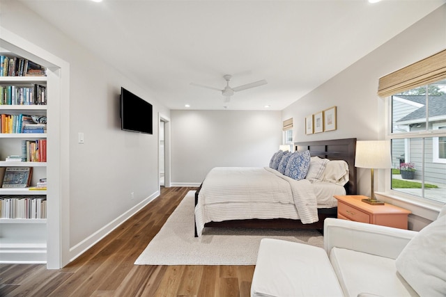 bedroom with ceiling fan and dark hardwood / wood-style floors