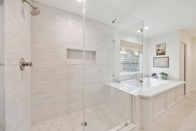 bathroom featuring tile patterned floors and independent shower and bath