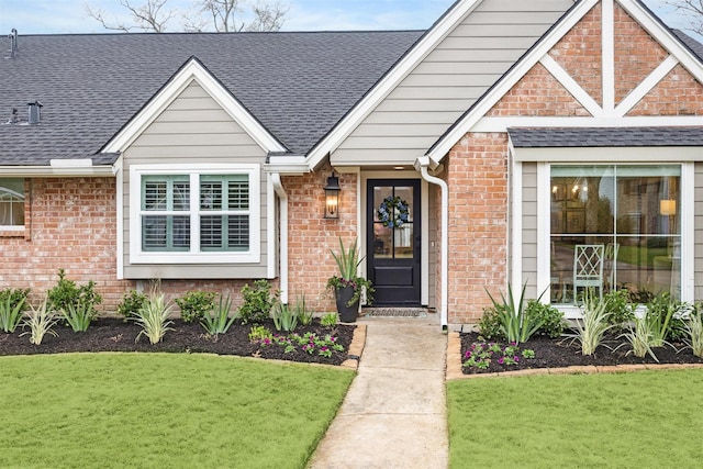 doorway to property with a lawn