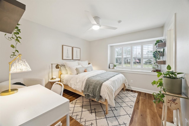 bedroom with hardwood / wood-style flooring and ceiling fan